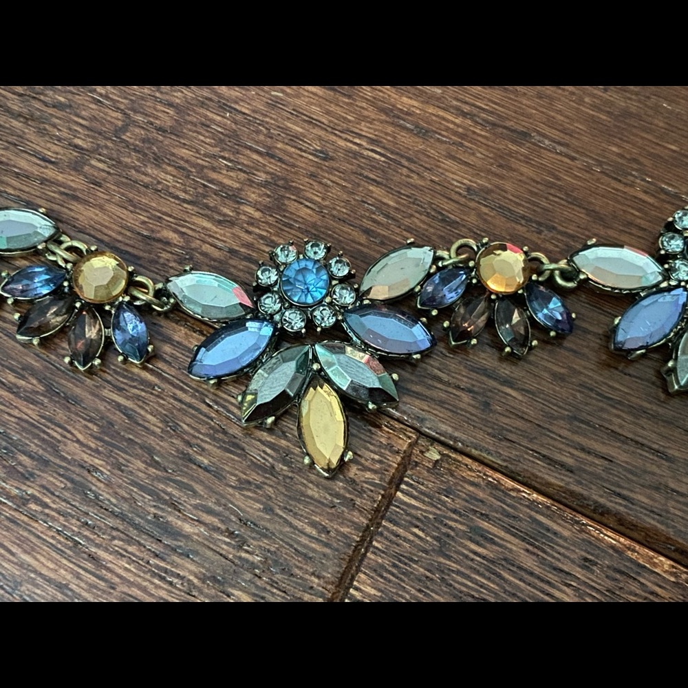 Small necklace with blue, green, and yellow gems.